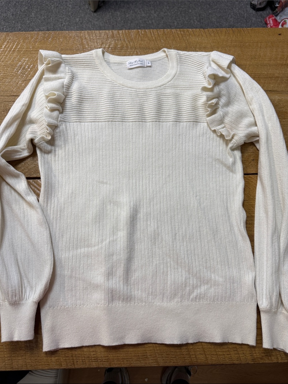 Ruffle Shoulder Ribbed Sweater in Cream